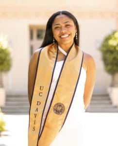 Young woman with UC Davis gold graduation stole